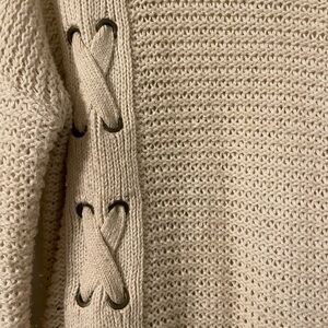 Tan sweater with laced up detail down one side.